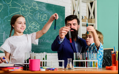 Chemistry themed club. Discover and explore properties of substances together. Kids can grow in area of club such as science. School club education. Teacher and pupils test tubes in classroom