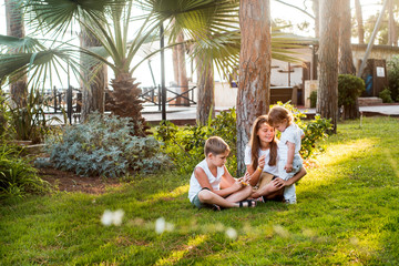 Kids play at tropical beach. Children playing at sea on family summer vacation on exotic island. Little boy in sun protection wear at swimming pool of resort. Holiday with young child. Kid at ocean.