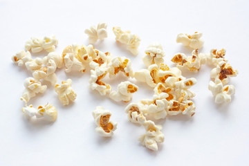 Light yellow fresh salted popcorn on white background. Close up food photography