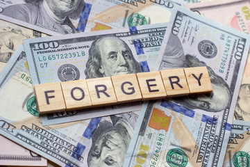 The word forgery on dollar usa background