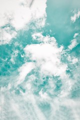 Beautiful white soft fluffy clouds on a cold green sky background
