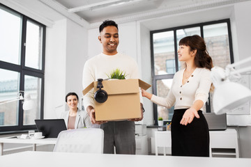 business, new job and corporate concept - indian male male employee with personal stuff and...