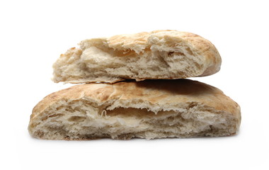 Loaf of bread broken in half isolated on black background