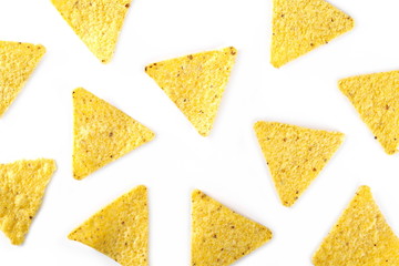 Corn tortilla chips pile, party snacks isolated on white background, top view