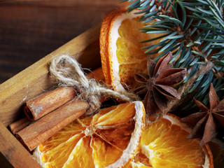 Christmas holiday composition : Beautiful close-up branches of spruce , of dry Oranges, Cinnamon sticks and star Anise  in  a wooden box.