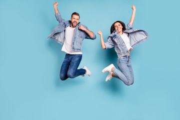 Photo of overjoyed joyful cute nice couple of spouses jumping flying in air happily while isolated...