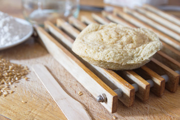 Homemade sponge cake on a wooden table in a rustic kitchen next to some ingredients. Traditional cuisine and health bakery concept with empty copy space for Editor's text.