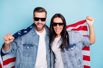 Portrait of cheerful spouses in eyewear eyeglasses scream yeah yes hold american flag wear denim...