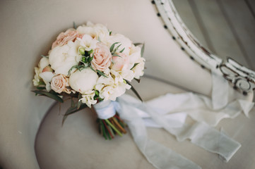 beautiful wedding bouquet of different flowers on a chair