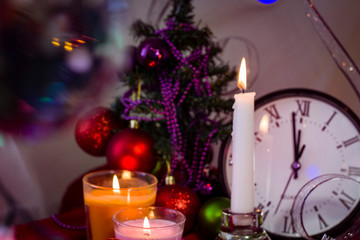  Happy New Year 2020. Christmas decorations with a clock of a Christmas fir tree on the background of lights and tinsel..