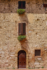 Fototapeta na wymiar old wall with windows and door