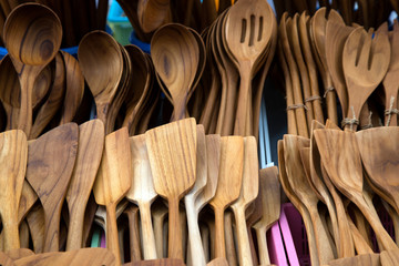 Carved cups, spoons, forks and other utensils of wood in traditional polish market.