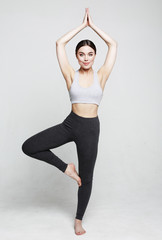 sport, yoga and people concept - lovely young woman doing yoga, sports exercises for relaxation and meditation