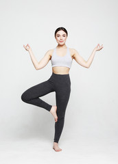 Obraz premium sport, yoga and people concept - lovely young woman doing yoga, sports exercises for relaxation and meditation