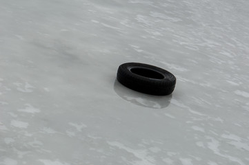 old tire on melting ice