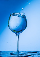glass, wine, drink, water, alcohol, wineglass, blue, isolated, empty, white, liquid, transparent, clear, beverage, clean, object, crystal, goblet, reflection, drop, bar, single, fresh, cold, celebrati