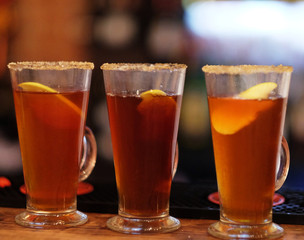 tea drink with spices in a tall glass, close up