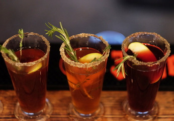 tea drink with spices in a tall glass, close up