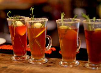 tea drink with spices in a tall glass, close up