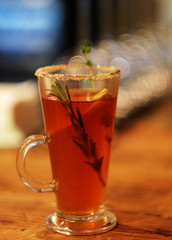 tea drink with spices in a tall glass, close up