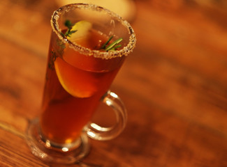 tea drink with spices in a tall glass, close up