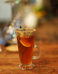 tea drink with spices in a tall glass, close up