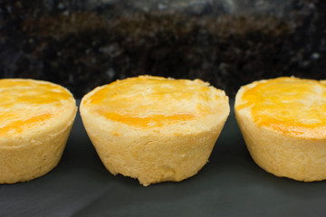 Traditional Brazilian mini chicken pies called empada in slate background