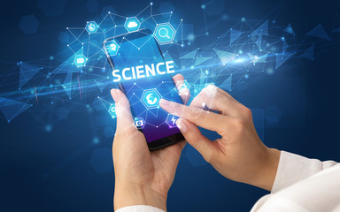 Female hand holding smartphone with SCIENCE inscription, modern technology concept