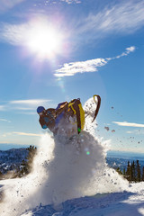 snowmobile jump. bright snowmobile in motion. the guy is flying on a snowmobile on a background of...