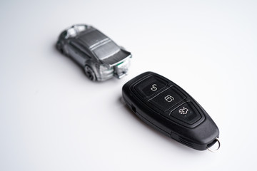 Car loan, Insurance, buy and sell and Auto Finance conceptual image with Car Key remote, die cast car and dollar bills 