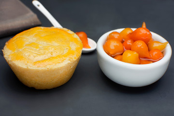 Traditional Brazilian mini chicken pie called empada with pepper pout in slate background