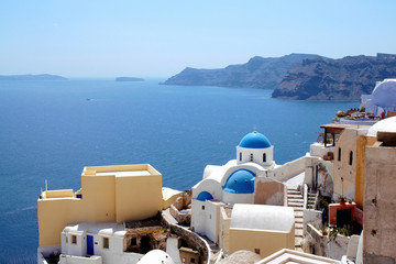 View of Oia, Santorini, Greece with the blue-domed Anastasis Church. The famous blue domed church...