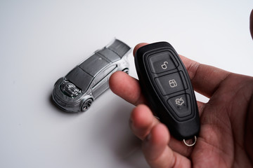 Car loan, Insurance, buy and sell and Auto Finance conceptual image with Car Key remote, die cast car and dollar bills 