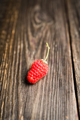 Freshly harvested raspberry on the rustic wooden background. Selective focus. Shallow depth of field.