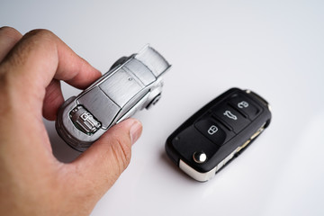 Car loan, Insurance, buy and sell and Auto Finance conceptual image with Car Key remote, die cast car and dollar bills 