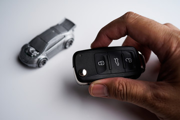 Car loan, Insurance, buy and sell and Auto Finance conceptual image with Car Key remote, die cast car and dollar bills 