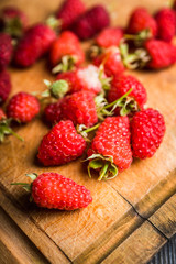 Freshly harvested raspberry on the rustic wooden background. Selective focus. Shallow depth of field.