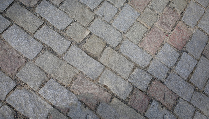 old pedestrian walkway on the street paved with stones
