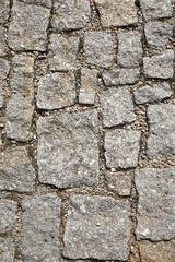 old pedestrian walkway on the street paved with stones