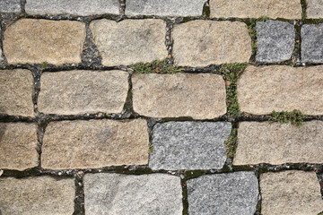 old pedestrian walkway on the street paved with stones