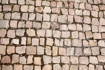 old pedestrian walkway on the street paved with stones