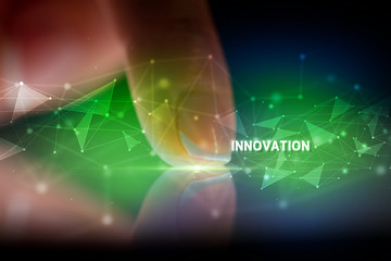 Finger touching tablet with INNOVATION inscription, business concept