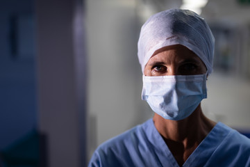 Fototapeta na wymiar Female surgeon standing at operation room