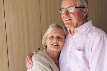 Couple posing while standing  at retirement home 