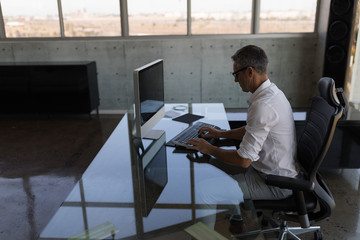 Male executive working on computer at desk