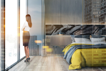 Woman in wooden and gray bedroom