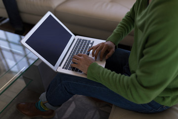 Male executive using laptop in office