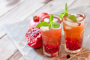 Mojito cocktail with pomegranate, mint, lemon juice and ice