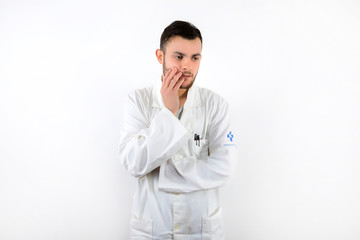 Young male doctor with beard worried and upset isolated on white background