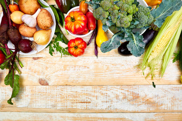 Fresh colorful organic vegetables from above. Top view, flat lay. Different vegetables for eating healthy on wooden background. Clean eating food frame. Copy space. Vegetarian, vegan..